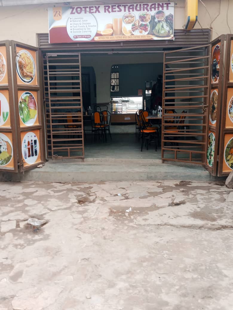 Customer at the mobile money counter, with MTN, Airtel and M-PESA signage
